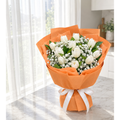 11 white tulip bouquet with Baby’s Breath and orange wrapping